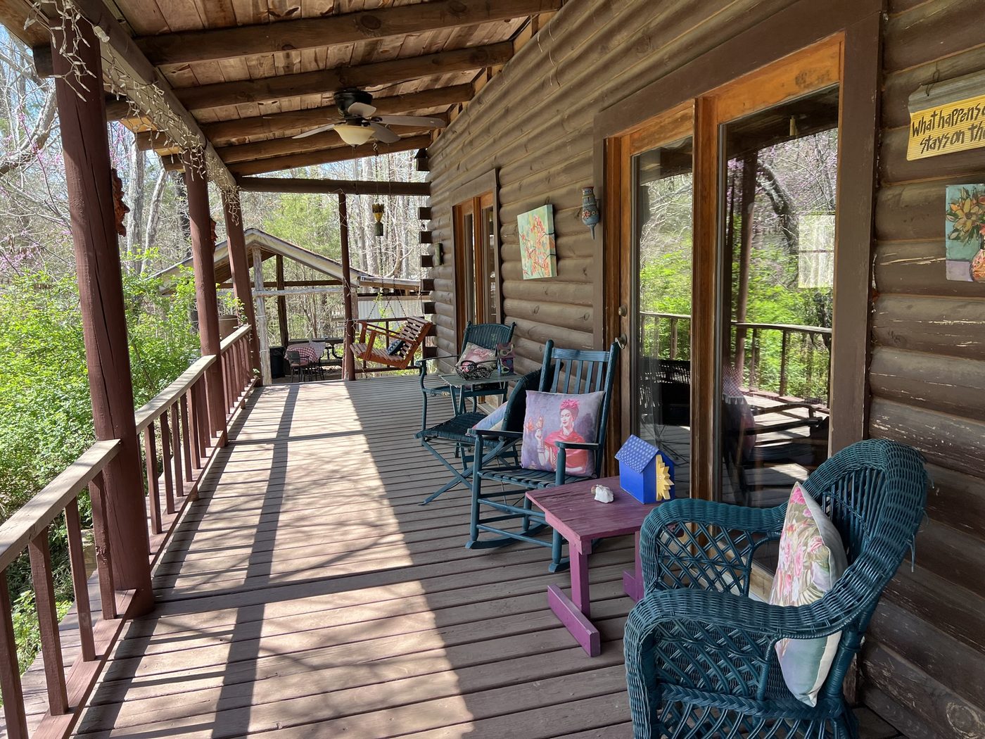 The covered porch at Sacred Grove overlooking the woods